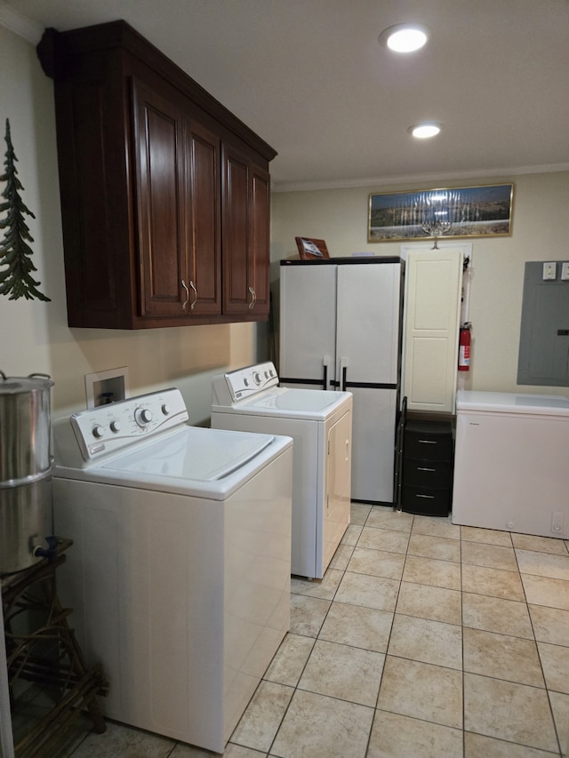 laundry room with light tile patterned flooring, cabinets, ornamental molding, and washing machine and dryer