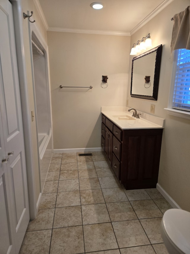 bathroom with crown molding, tile patterned flooring, vanity, and toilet