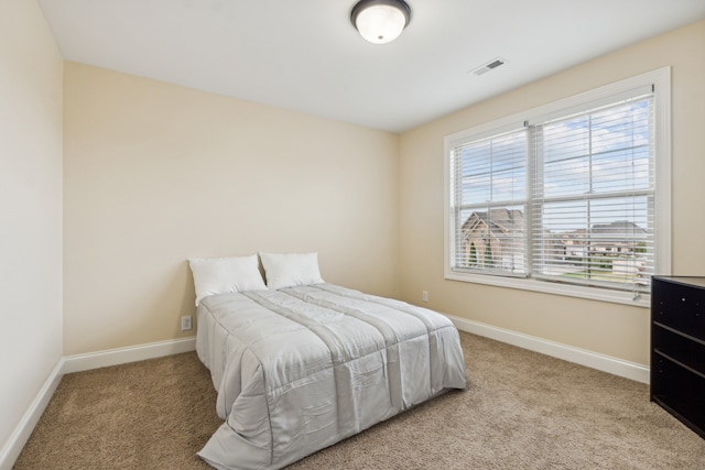 bedroom featuring light colored carpet