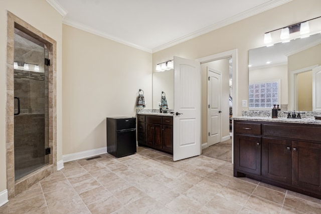 bathroom with vanity, an enclosed shower, and crown molding