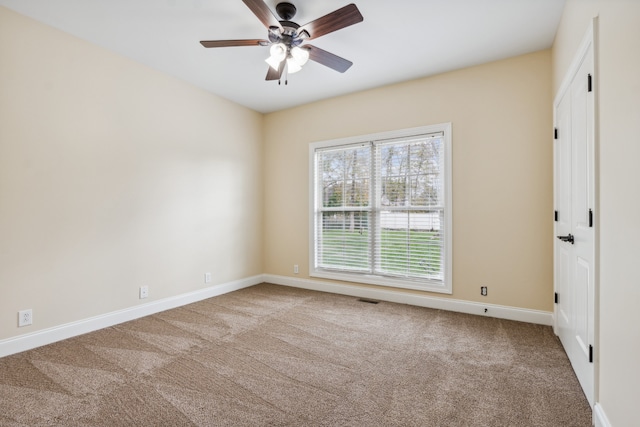 spare room featuring carpet and ceiling fan