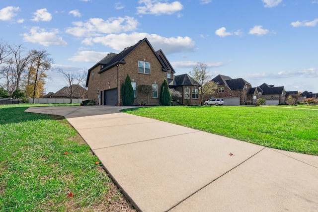 view of front of property with a garage and a front lawn