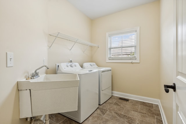 laundry area featuring separate washer and dryer and sink