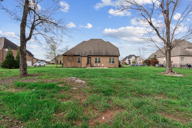 back of property with a yard