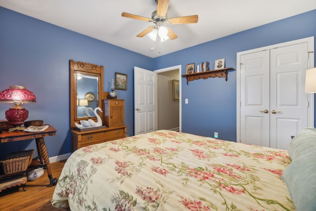 bedroom featuring hardwood / wood-style floors, a closet, and ceiling fan