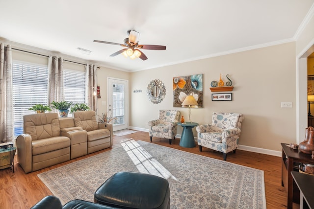 living room with hardwood / wood-style floors, ceiling fan, and ornamental molding