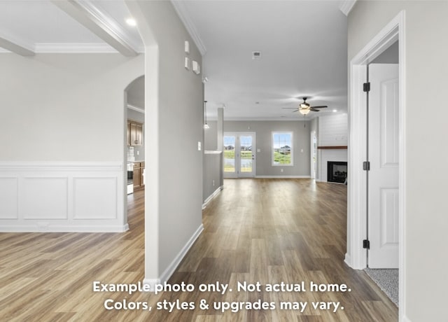 hallway with hardwood / wood-style floors and ornamental molding