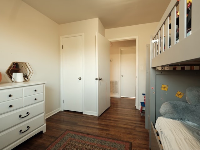 bedroom with dark hardwood / wood-style floors