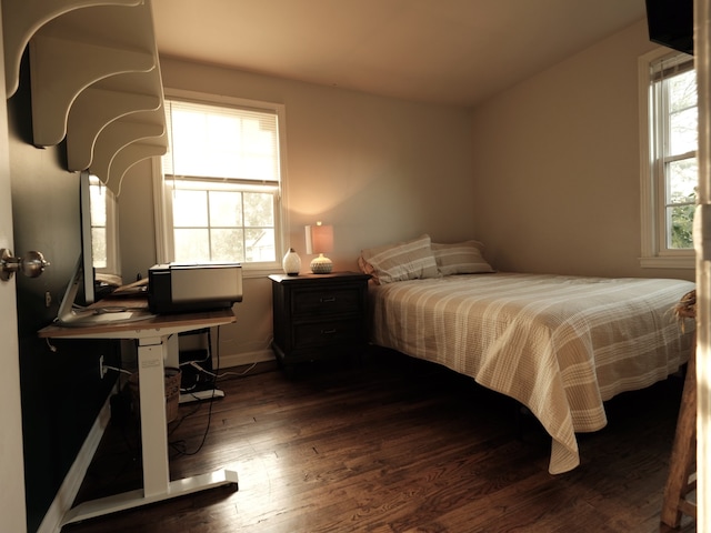 bedroom with dark hardwood / wood-style flooring