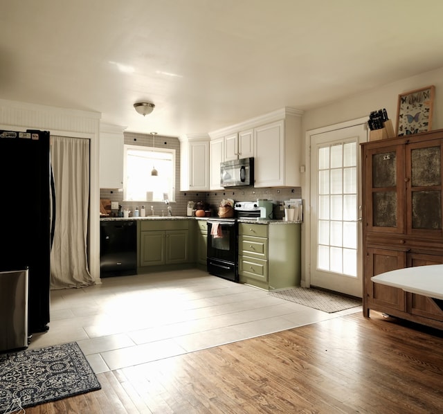 kitchen with black appliances, a healthy amount of sunlight, white cabinetry, and green cabinetry