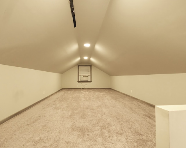 additional living space with carpet flooring, cooling unit, and vaulted ceiling