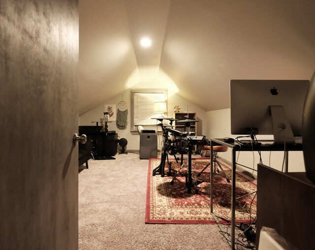 carpeted office space with lofted ceiling