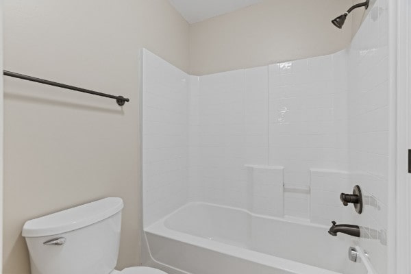 bathroom featuring toilet and shower / bathtub combination