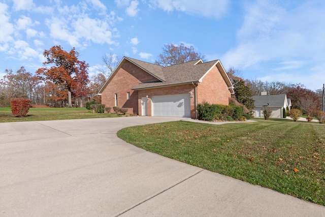 view of side of home featuring a yard and a garage