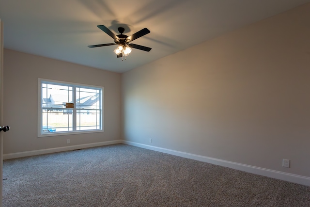 spare room featuring carpet flooring and ceiling fan