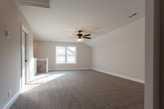 interior space with vaulted ceiling, carpet, and ceiling fan