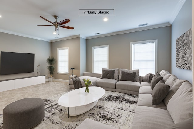 living room featuring crown molding, carpet, and ceiling fan