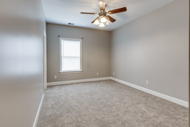 spare room with ceiling fan and light carpet