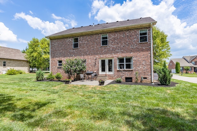 back of property featuring a yard and a patio