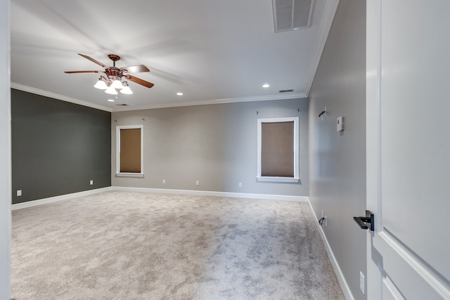 carpeted empty room featuring ceiling fan and ornamental molding