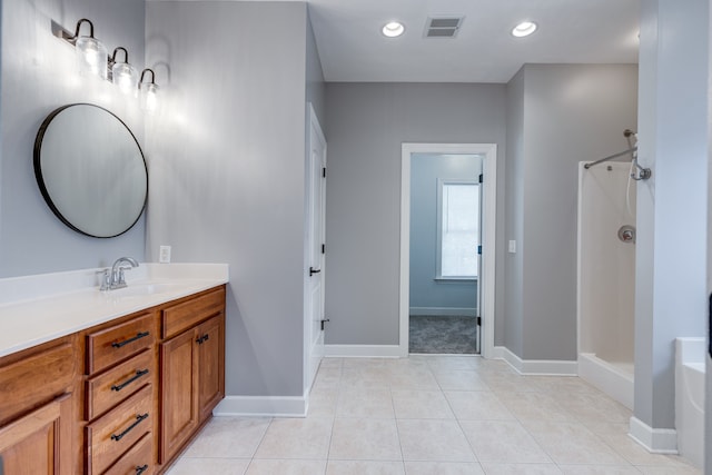 bathroom featuring a shower, tile patterned flooring, and vanity