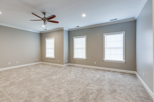 carpeted empty room featuring ceiling fan and ornamental molding