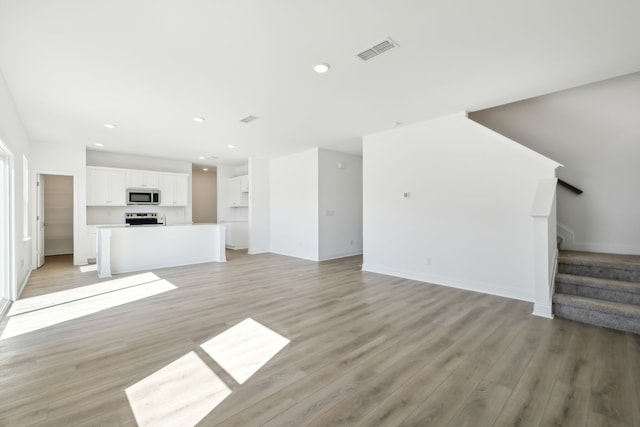 unfurnished living room featuring light hardwood / wood-style floors