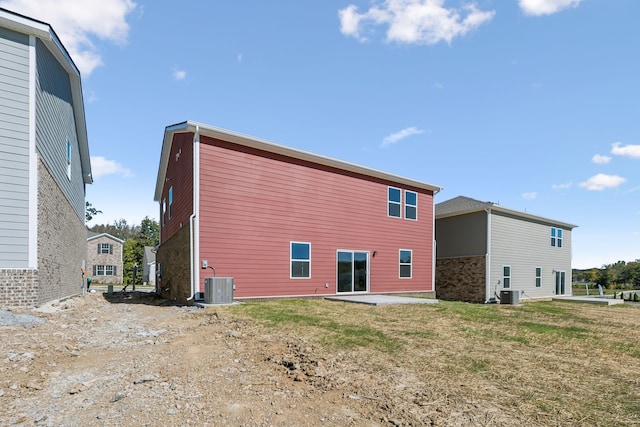 rear view of house featuring central air condition unit and a patio