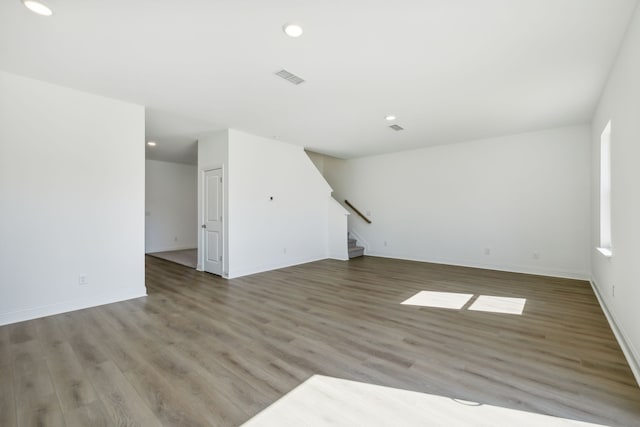 unfurnished living room with wood-type flooring