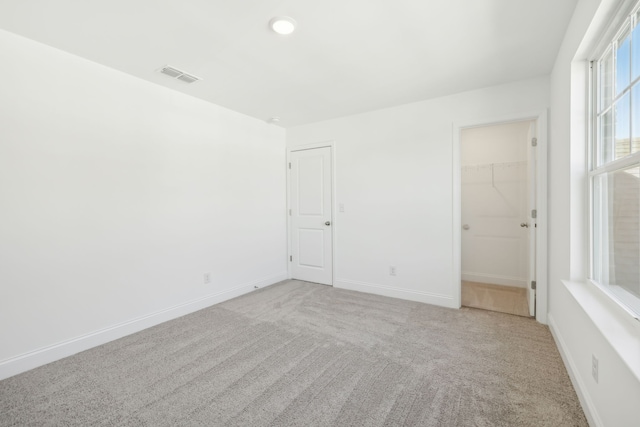 unfurnished room featuring light carpet