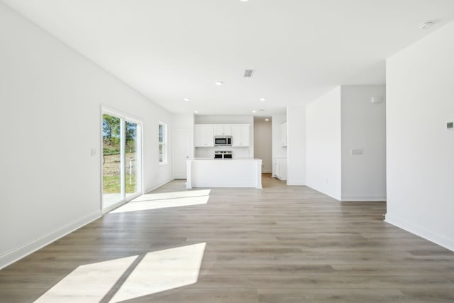 unfurnished living room with wood-type flooring