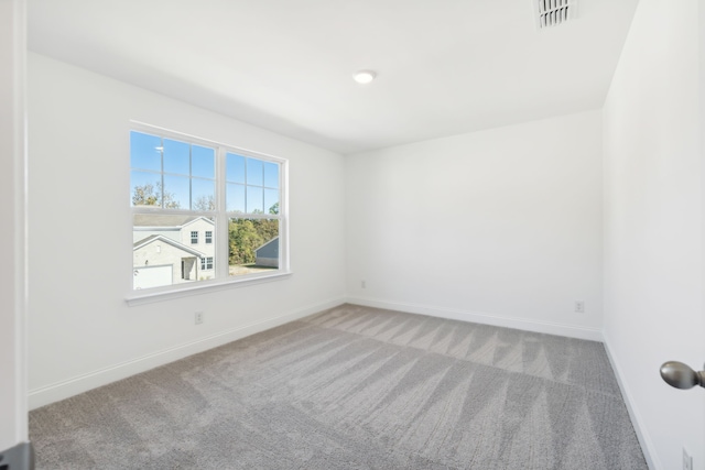 unfurnished room featuring carpet