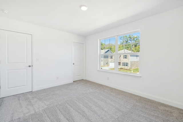 empty room featuring light carpet