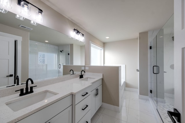 bathroom featuring vanity and separate shower and tub