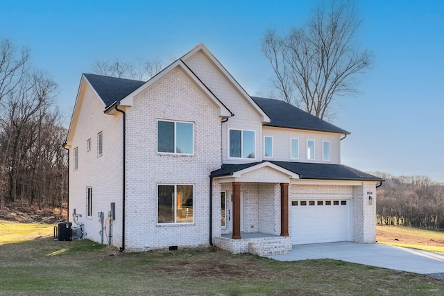 view of front of property featuring a garage, central air condition unit, and a front yard