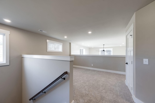 hallway featuring light colored carpet