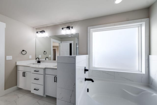 bathroom featuring vanity and a tub