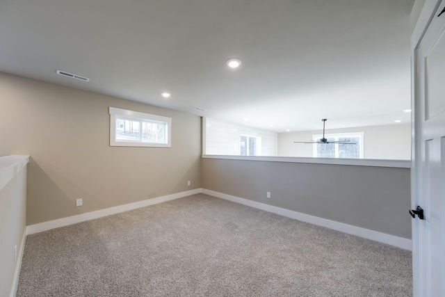 spare room featuring light carpet and a healthy amount of sunlight