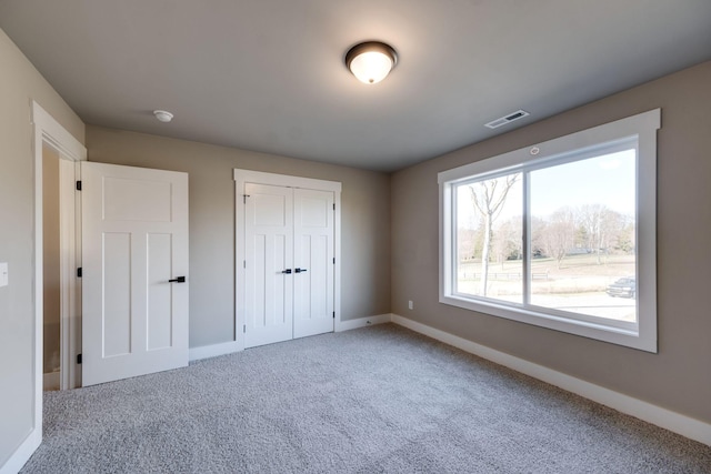 unfurnished bedroom featuring carpet and a closet