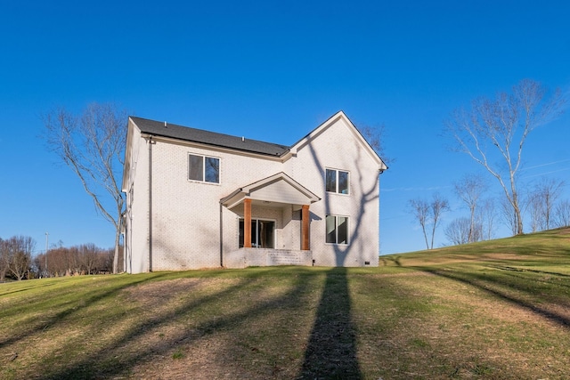 back of house featuring a yard