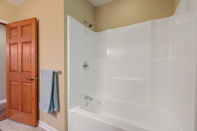 bathroom with tile patterned flooring and shower / tub combination