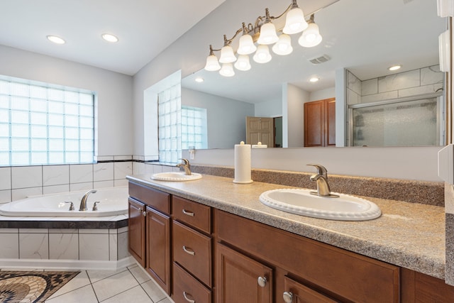 bathroom with tile patterned flooring, vanity, and independent shower and bath