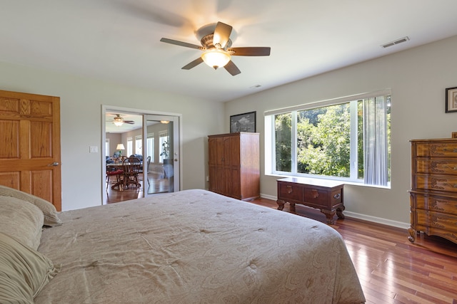 bedroom with hardwood / wood-style floors and ceiling fan