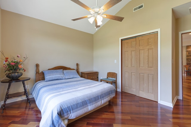 bedroom featuring ceiling fan, dark hardwood / wood-style floors, high vaulted ceiling, and a closet