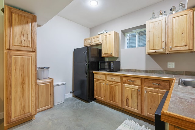 kitchen featuring black appliances and tile counters