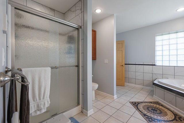 bathroom featuring toilet, separate shower and tub, tile patterned floors, and tile walls