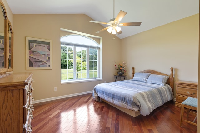 bedroom featuring ceiling fan, dark hardwood / wood-style flooring, and vaulted ceiling