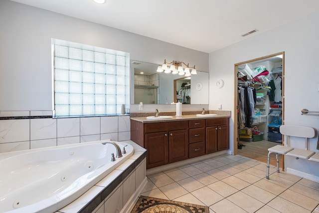 bathroom with tile patterned flooring, vanity, and shower with separate bathtub