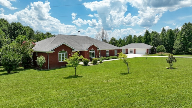 ranch-style house featuring a front yard and a garage
