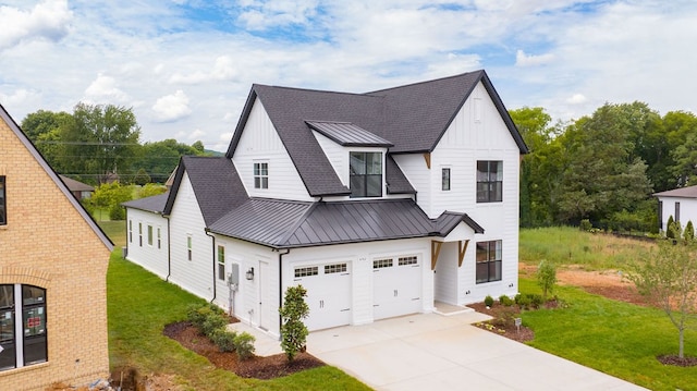 modern farmhouse featuring a garage and a front lawn